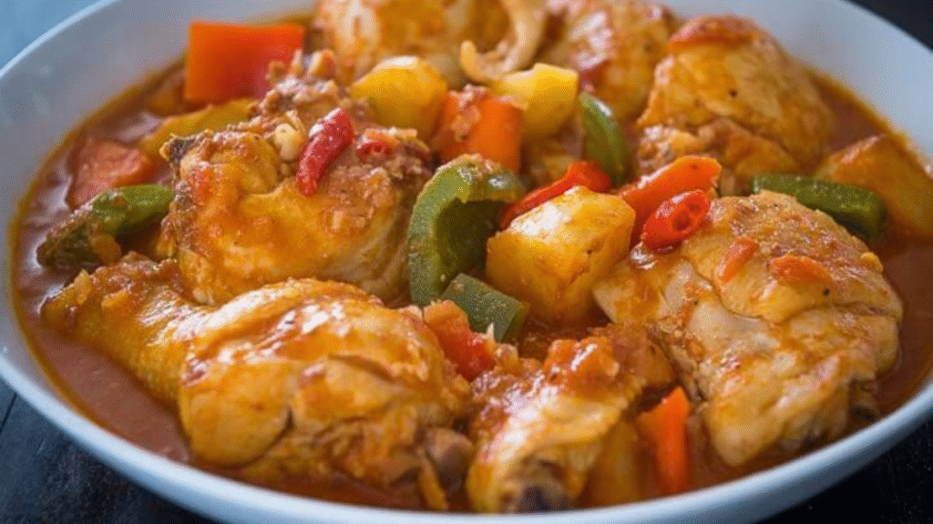 Best Chicken Caldereta Recipe – Simple, Creamy & Authentic Filipino Flavor! 19 Creamy Filipino Chicken Caldereta in a bowl with potatoes, carrots, and bell peppers in rich tomato sauce.