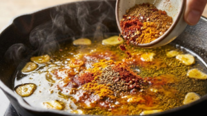 Pharaoh Sauce Recipe 6 Adding ground spices to garlic oil for Pharaoh sauce