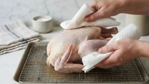 Whole Pheasant Recipes: How to Cook a Juicy, Flavor-Packed Pheasant at Home 4 Brined whole pheasant being patted dry with paper towels