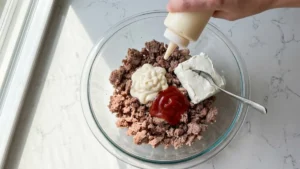 Braunschweiger Dip Recipe – Easy Creamy Party Appetizer 4 Mayonnaise, ketchup, and cream cheese added to braunschweiger in a bowl.