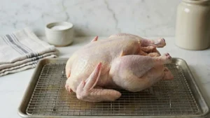 Whole Pheasant Recipes: How to Cook a Juicy, Flavor-Packed Pheasant at Home 5 Whole pheasant resting uncovered on a rack to air dry before cooking