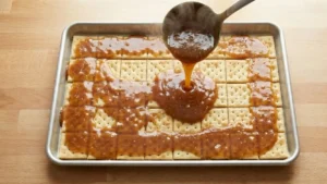 Valentine’s Day Crack Candy – The Sweet & Salty Treat Everyone Is Obsessed With 7 Pouring toffee over crackers