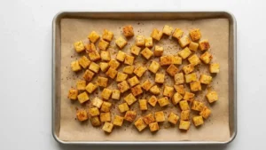 Papá Asado Recipe: The Ultimate Crispy Roasted Potato Recipe Everyone Loves 6 Seasoned potatoes arranged on baking tray