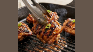 Molokai Chicken Recipe 8 Flipping Molokai chicken while grilling.