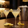Two lemon drop martinis served on a bar table with fresh lemons