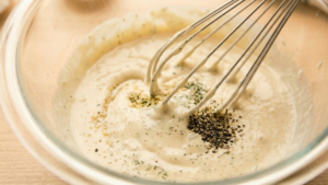 Mixing ranch dressing until creamy